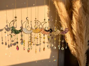 Detailed view of 7pcs colorful natural stone crystal moon sun catchers in warm sunlight