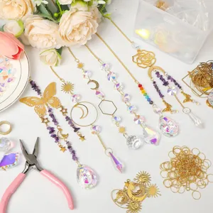 Detailed view of DIY suncatcher kit with K9 crystals, gold charms, and craft pliers.