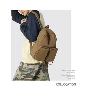 Modern khaki large capacity backpack featuring double front pockets shown on a male model