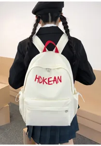 Sac à dos scolaire grande capacité avec broderie de lettres rouges sur une toile blanche