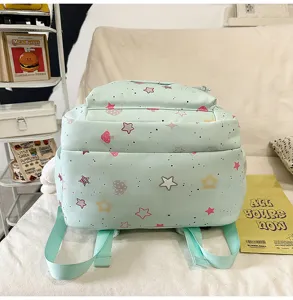 Detail view of the cute mint green student backpack with lovely star and mushroom prints.