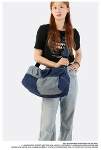 Detailed shot showing the large denim patchwork crossbody bag styled on a model