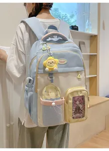 College style color block student backpack with plush star pendant and large capacity for school.