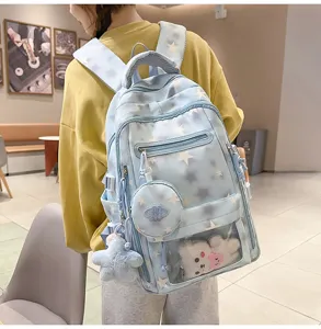 Zaino da scuola azzurro con stelle bianche, ciondolo orsetto di peluche e tasche multiple