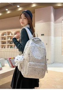 Detailed shot of a stylish white star-print multi-compartment student backpack for daily use.