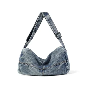Washed denim crossbody bag with a vintage distressed texture and adjustable strap