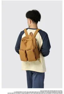 Back view of a large capacity mustard yellow casual backpack with double front pockets