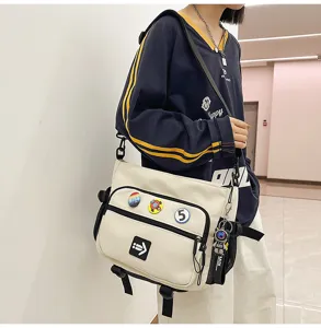 Korean style cream workwear messenger bag for students with badges and adjustable strap