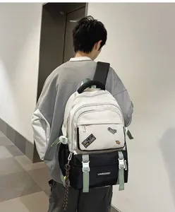 Detailed view of white and black color-block school backpack with cute badge labels