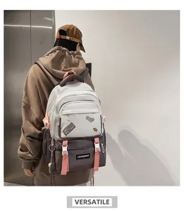 Stylish school backpack with trendy color-block design and decorative patches on model