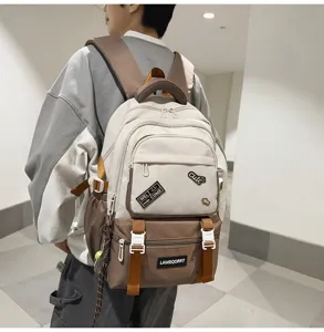 Back view of a stylish contrast color student backpack with decorative patches on model