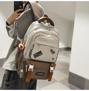 Close-up of stylish color-block school backpack with decorative patches