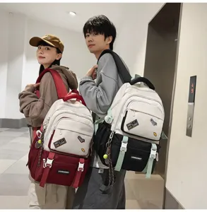 Detailed view of color-block school backpacks with decorative patches on models