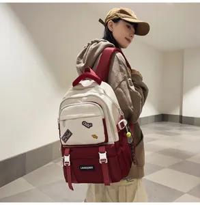 Lifestyle view of a girl wearing a red and cream color-blocked backpack with patches