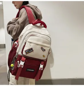 Side view detail of stylish contrast color school backpack with patches worn by model