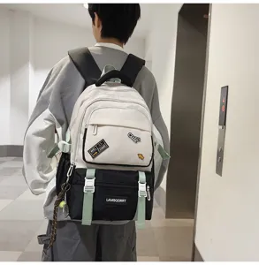 Detail view of color-block school backpack with cute patches worn by student in hallway
