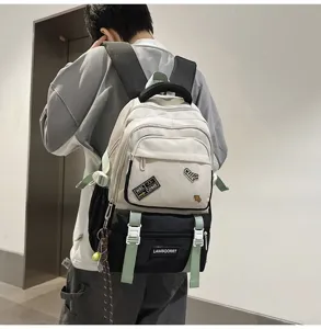 Close-up detail of contrast color school backpack with trendy patches worn by a student model.