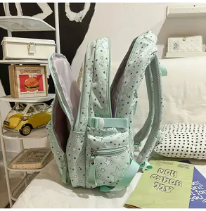 Mint green star print school backpack with large capacity and multiple compartments.