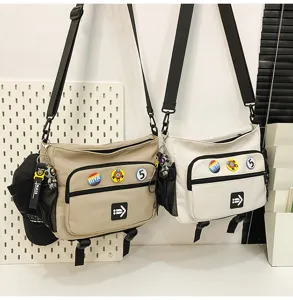 Large capacity urban messenger bags in two colors with decorative badges and street style