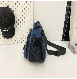 Side profile of a blue large capacity messenger bag with a black mesh side pocket.