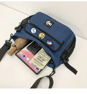 Detailed view of blue large capacity messenger bag showing storage for iPad and umbrella