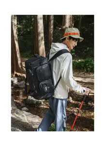 Professional action shot of a large capacity black sports gym bag for travel and hiking