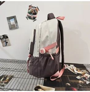 Side view of a stylish color-blocking school backpack with adjustable pink straps