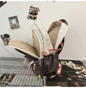 Interior view of dual-colored student backpack showing large capacity and compartments