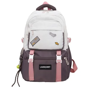 Front detail of a color-block school backpack with cute patches and tennis keychain
