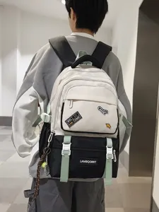 Stylish white and black contrast color student backpack with cute patches and green straps