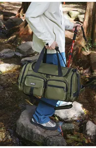 Detailed view of the large olive green travel duffel bag in an outdoor setting