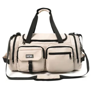 Frontal view of a beige sports duffel bag showing its multiple pockets and strap.