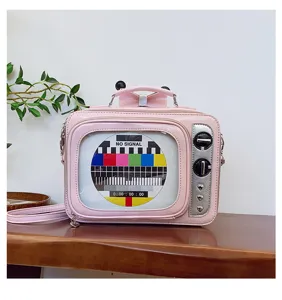 Detail view of a creative pink retro TV-shaped PU handbag featuring a test signal pattern