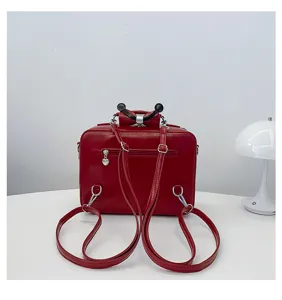 Back view of a red vintage TV-shaped PU leather backpack with heart zipper pull