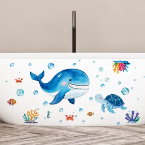 Cute waterproof ocean whale and turtle wall decals applied on white bathtub surface