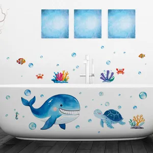 Detail of whale and turtle ocean themed stickers applied to a white bathtub surface