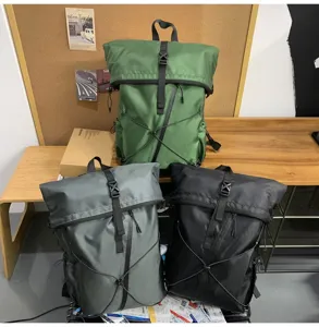 Collection of three large roll-top backpacks in green, grey, and black for daily commute.