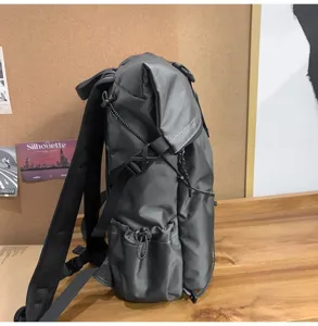 Side view of a premium grey roll-top business backpack showing side pocket and texture
