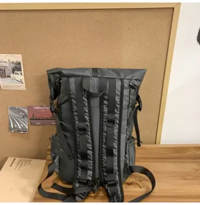 Back view of a gray roll-top business backpack showing ergonomic straps and padding.
