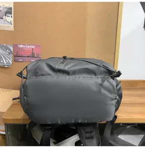 Detailed top view of a durable grey business backpack featuring a drawstring closure system