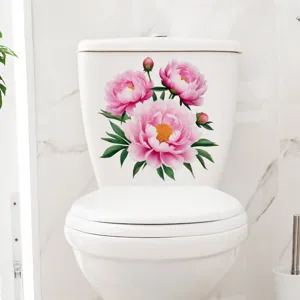 Detailed view of pink peony floral stickers applied to a white ceramic toilet tank