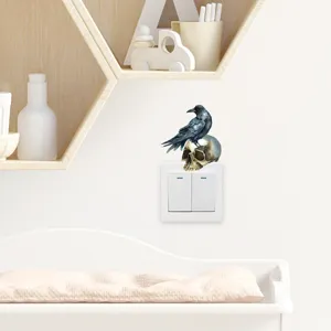 Gothic raven and skull switch sticker on a white panel in a modern room decor