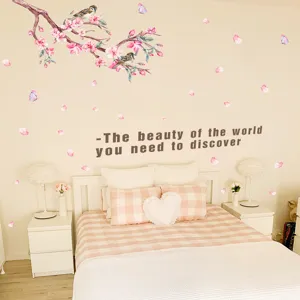 Romantic peach blossom wall stickers with birds applied in a cozy bedroom scene