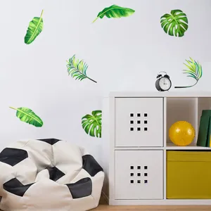 Tropical green leaf wall stickers applied to a white wall in a modern room setting.