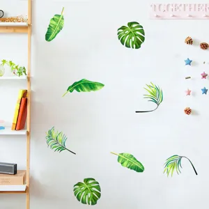 Detailed view showing realistic tropical leaf wall stickers on a clean white interior wall