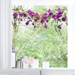 Purple floral static cling window sticker decorating a bright living room window.