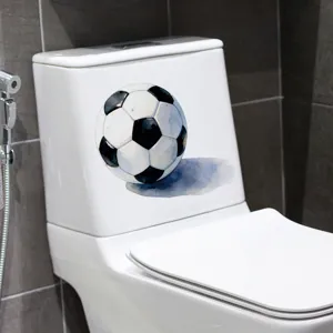 Waterproof watercolor soccer ball sticker applied on a white ceramic toilet tank detail