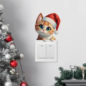 Detalle de una linda pegatina navideña de gato pelirrojo en un interruptor de luz
