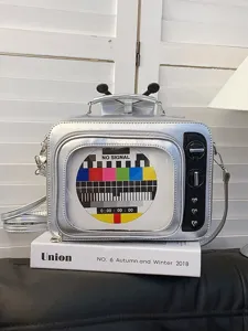 Silver retro TV shaped PU leather crossbody bag featuring colorful test pattern design