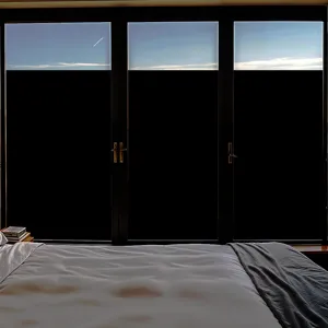 Blackout privacy window film static cling sticker applied to large bedroom windows